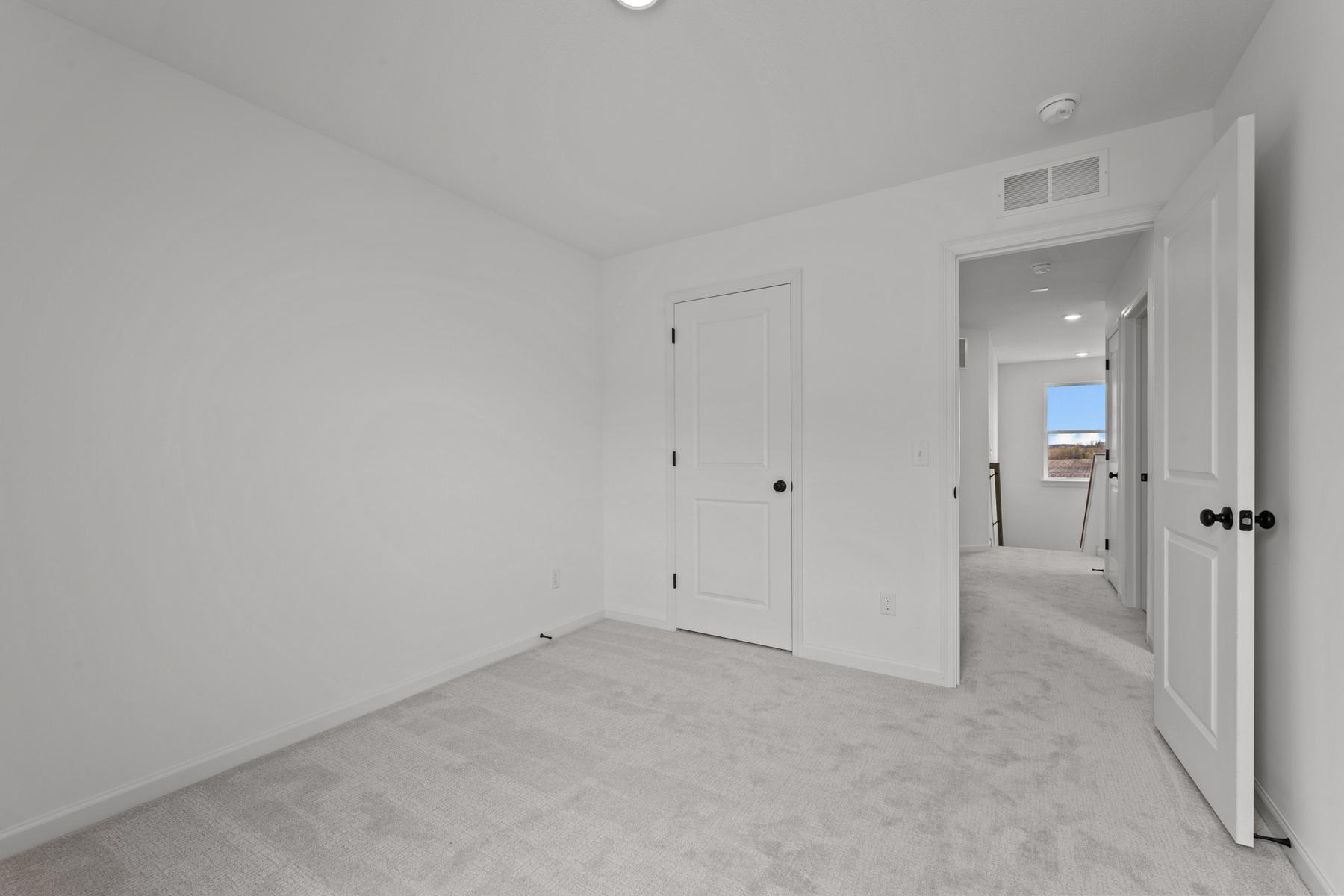 Comfortable secondary bedroom in the McBee plan ideal for guests or family use. Images are from a similar home, interior selections may differ