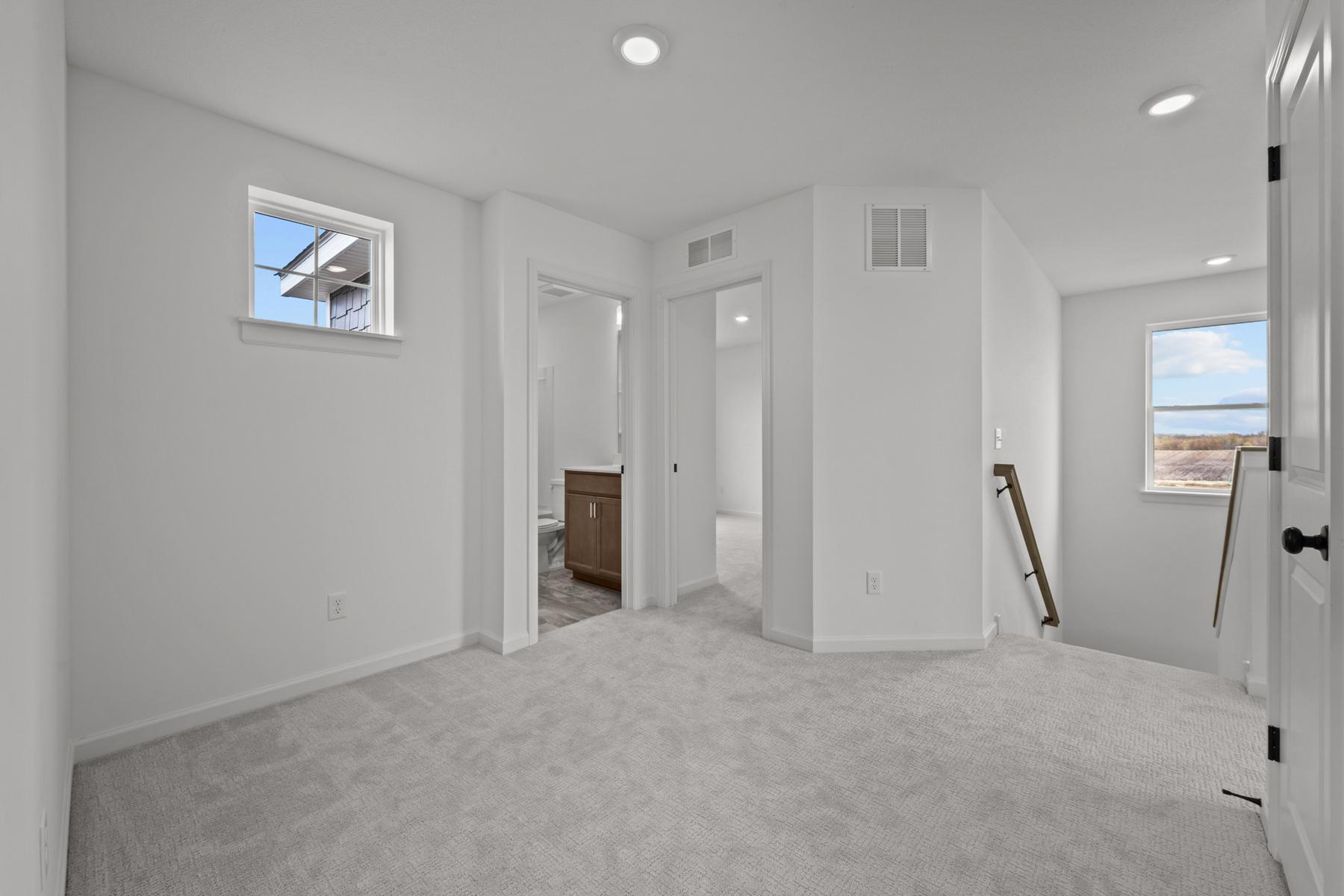 Open loft in the McBee plan ideal for playroom, media, or secondary living area. Images are from a similar home, interior selections may differ