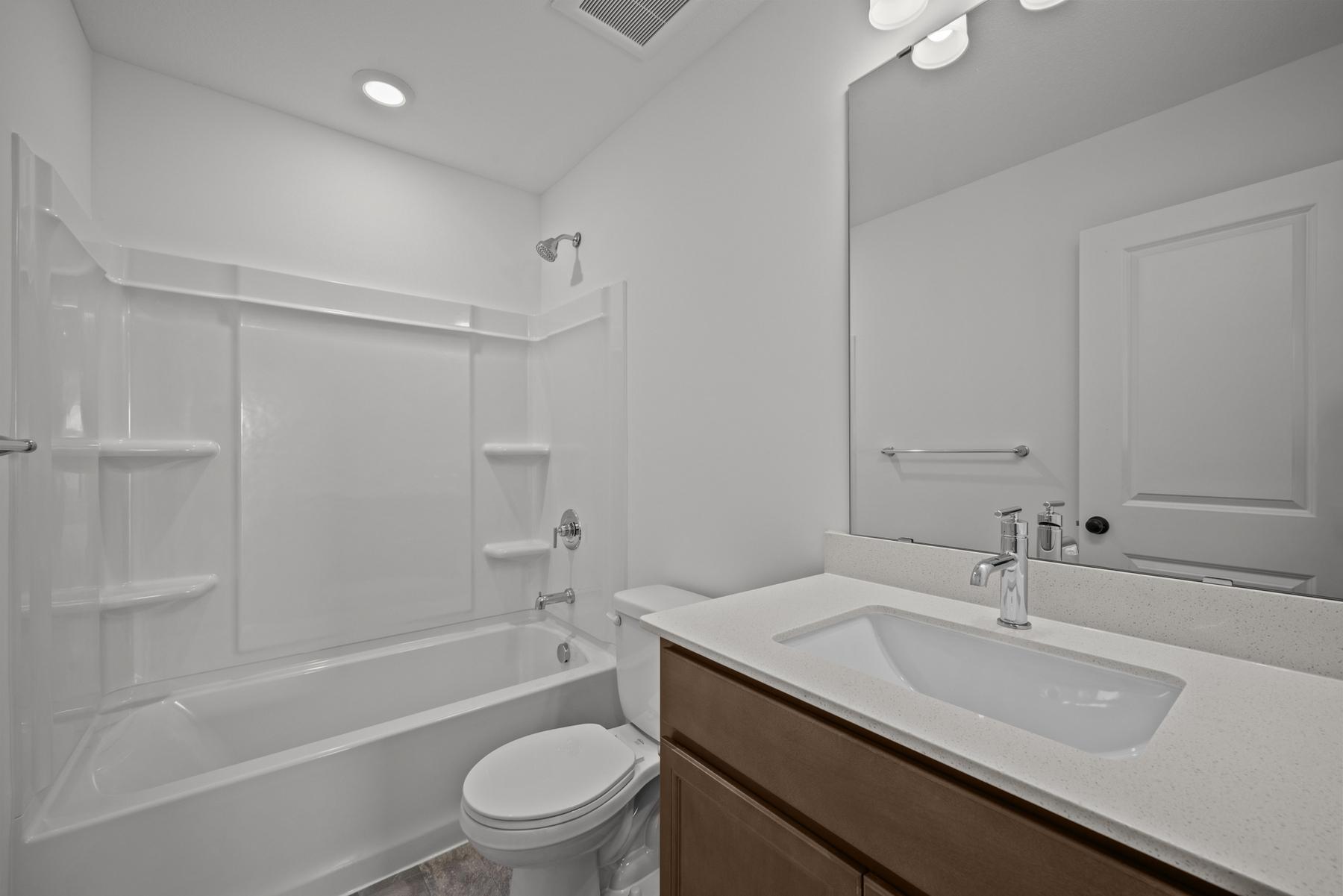 Convenient 3/4 bath in the McBee plan serving guests or secondary bedrooms. Images are from a similar home, interior selections may differ