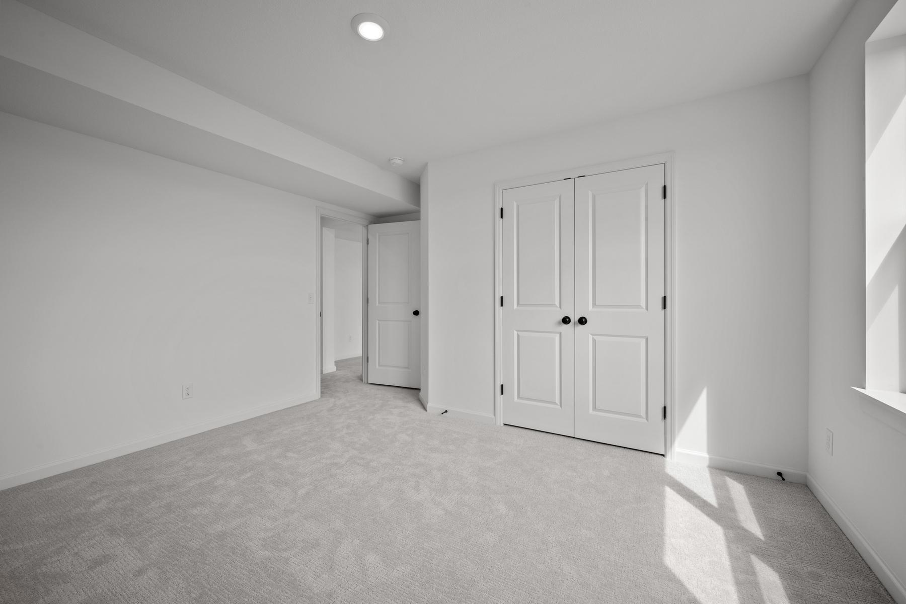 Comfortable secondary bedroom in the McBee plan ideal for guests or family use. Images are from a similar home, interior selections may differ