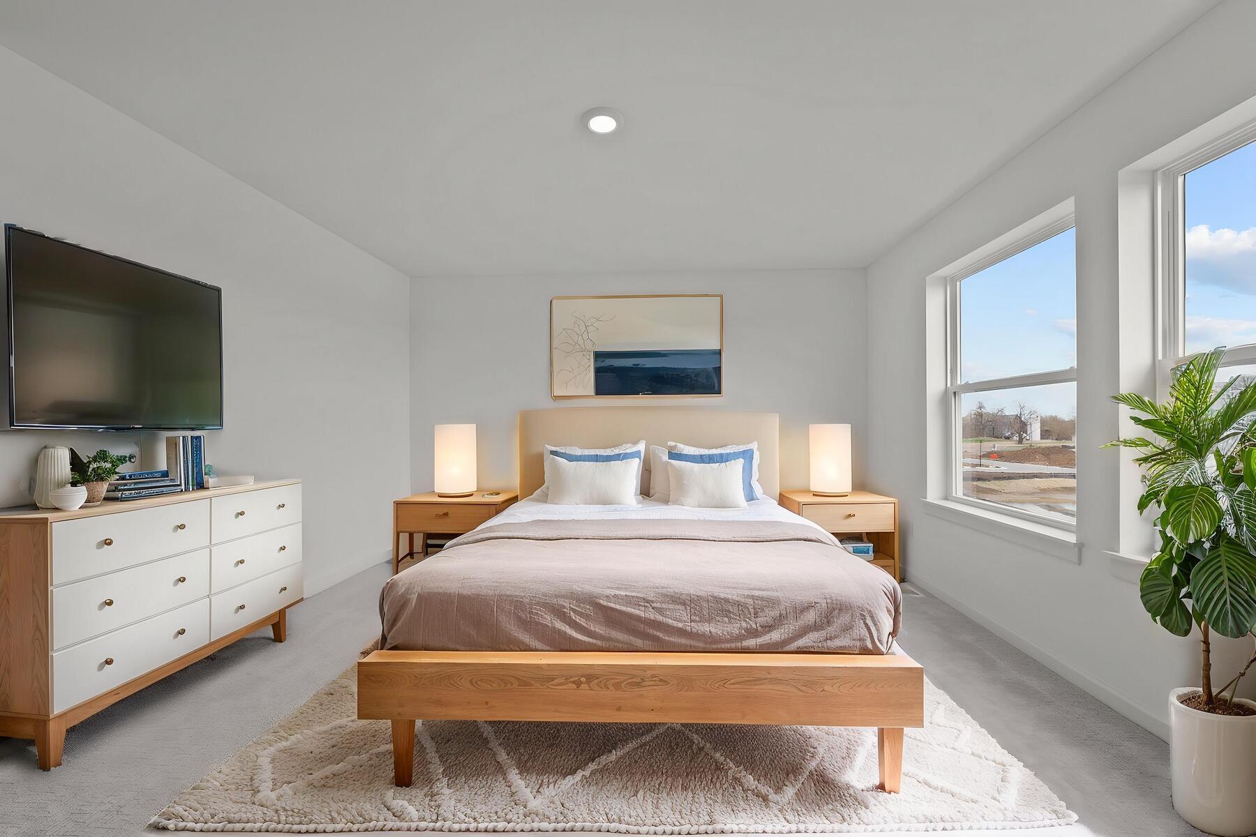 Private primary suite in the McBee plan offering comfort and separation. Images are from a similar home, interior selections may differ - Virtual Staging