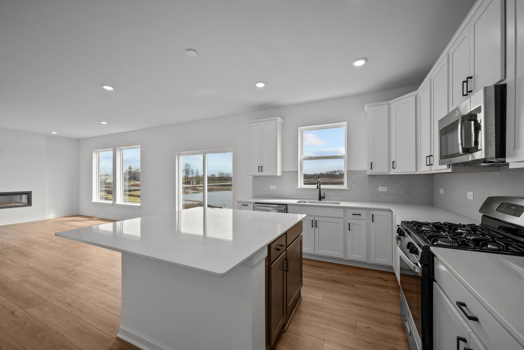 Central kitchen in the McBee plan designed for daily meals and casual gatherings. Images are from a similar home, interior selections may differ