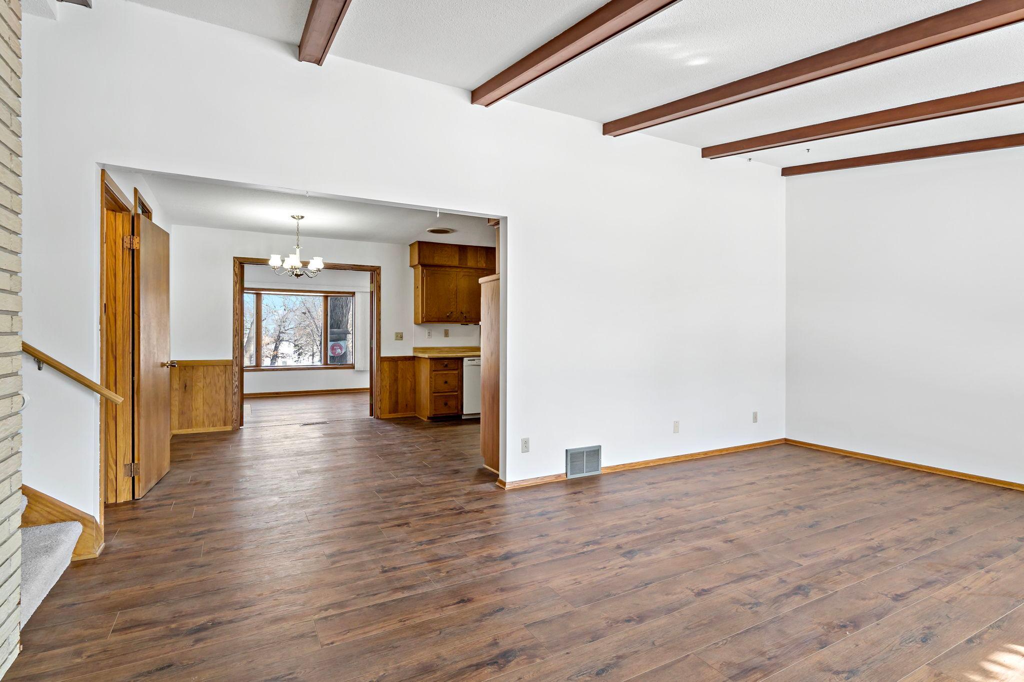 New flooring throughout main level. From living room, looking through kitchen to sunroom.