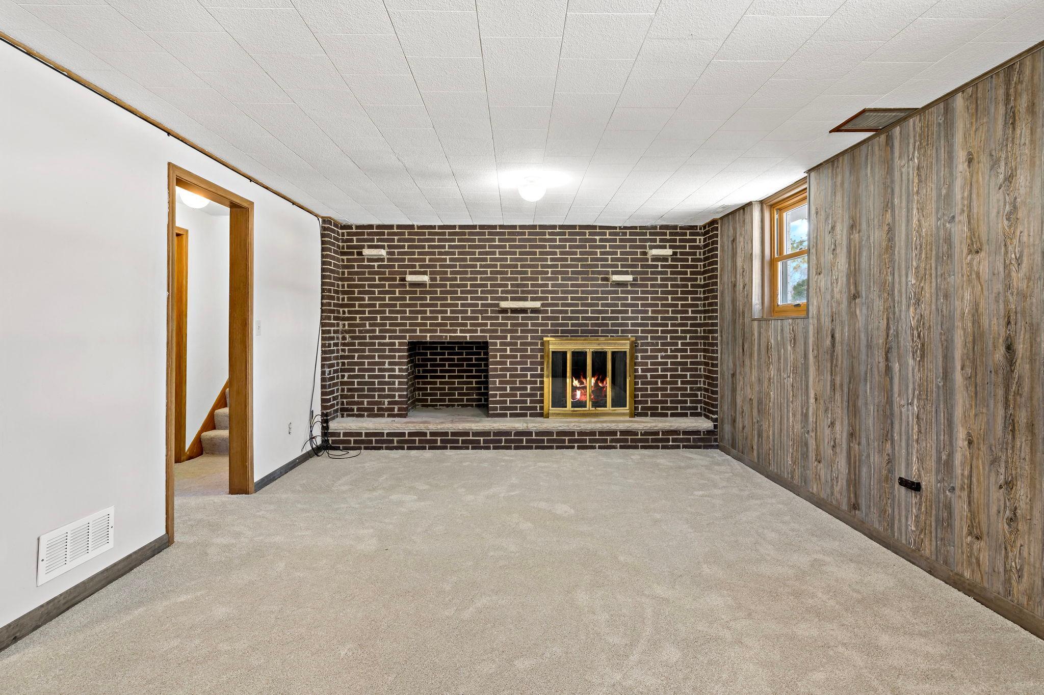 Wood-burning fireplace in lower-level family room. New carpet and paneling in 2026.