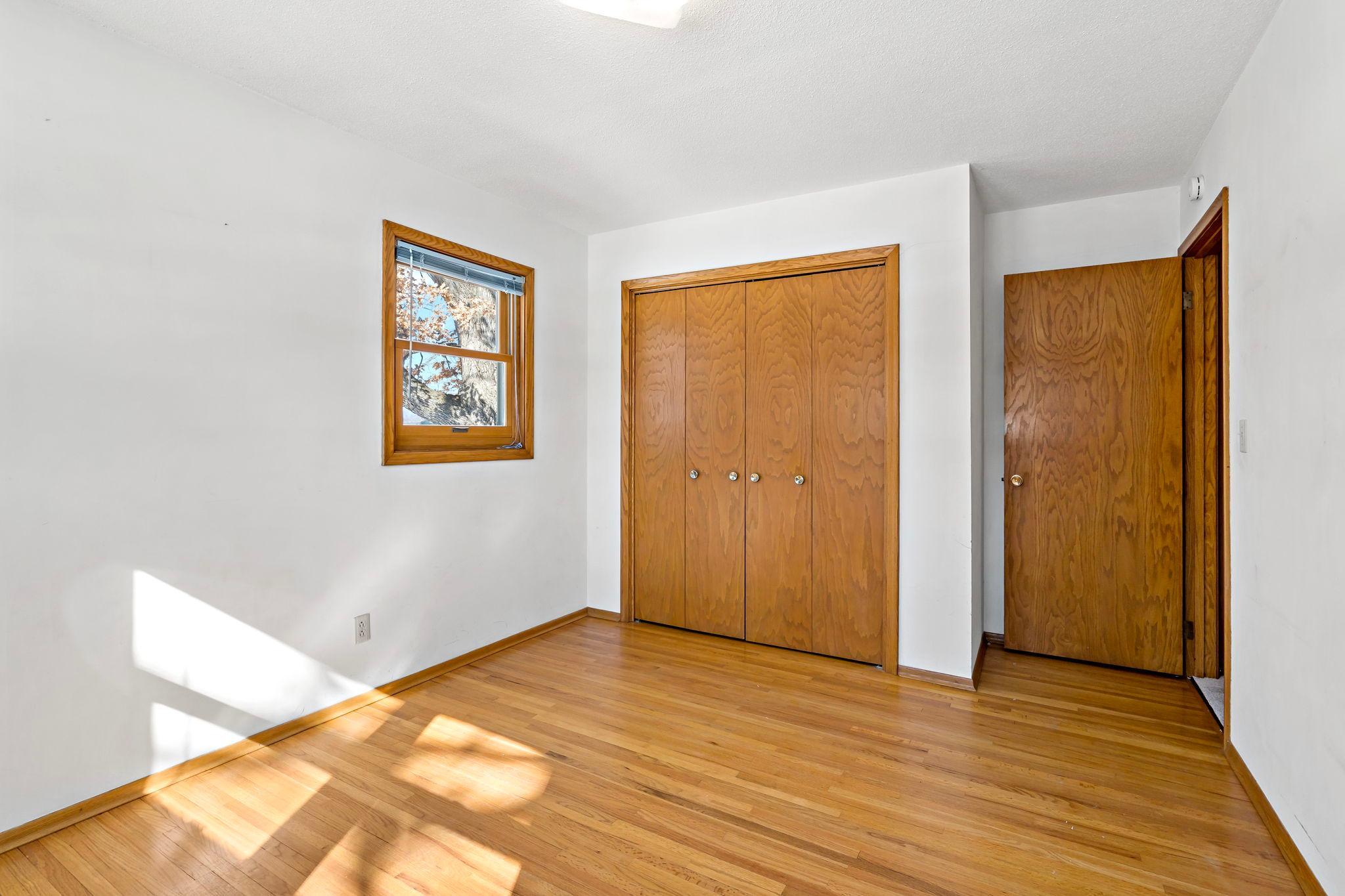 Third bedroom with original hardwood flooring.