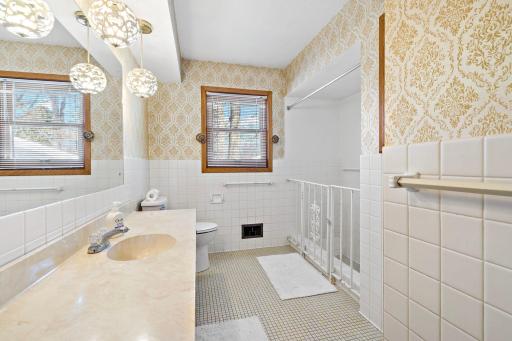 Upper level full bath with gorgeous tile flooring.