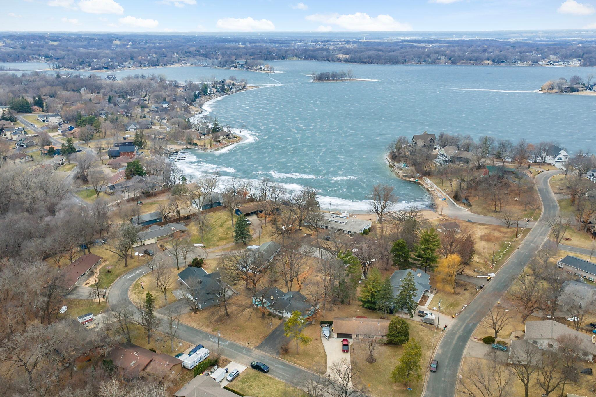 Beautiful setting on .43 acre filled with mature oak trees and lake lifestyle on Lower Prior Lake. Association maintained two acres of common area with private sandy beach, firepit, covered picnic area and private boat launch.
