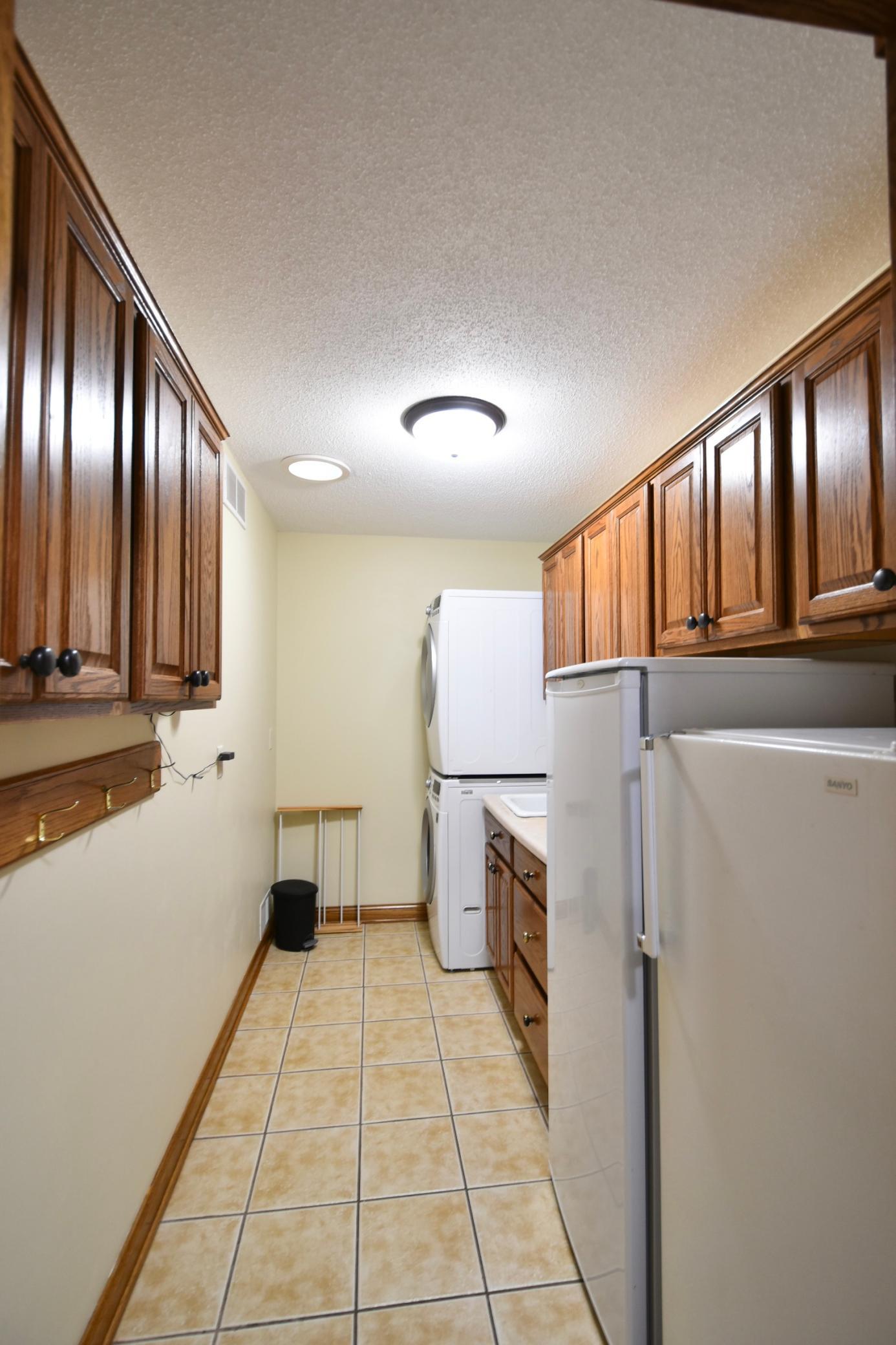 Main floor laundry-extra freezer & refrigerator will convey with property