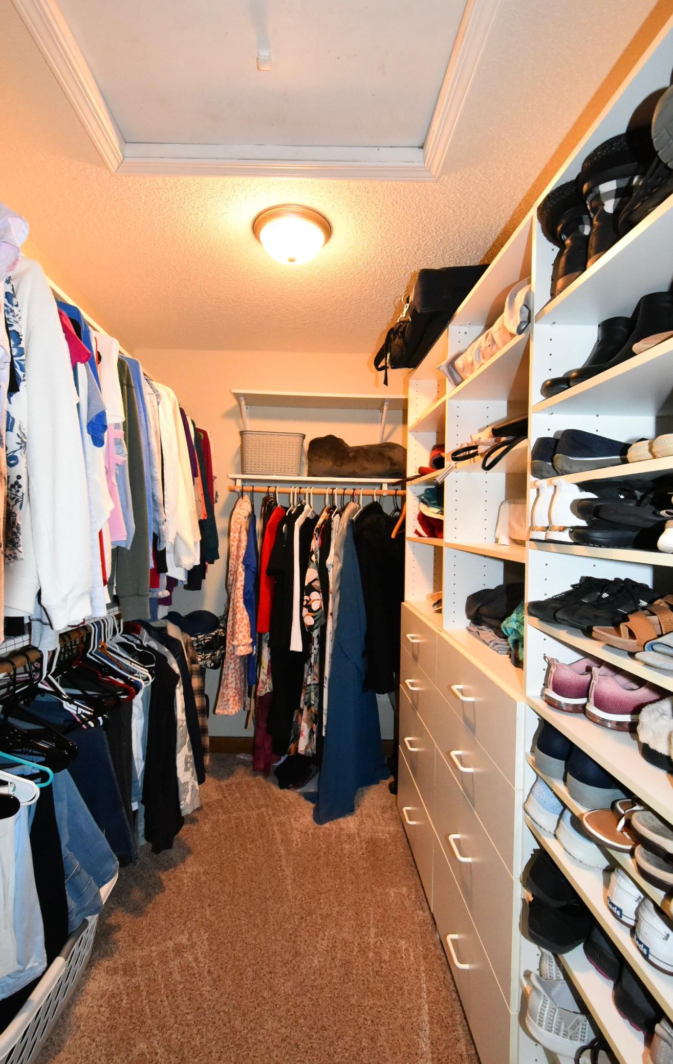 Walk-in closet with custom shelving-primary bedroom