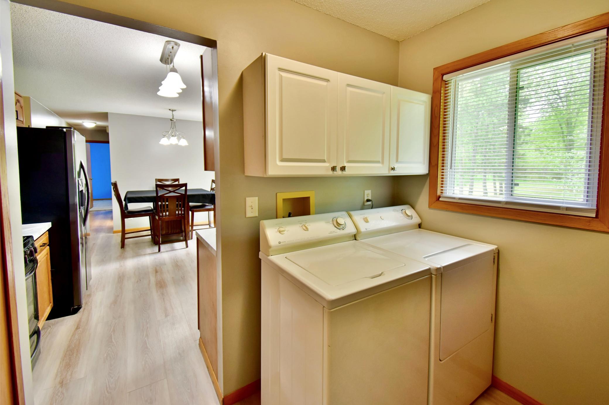 Main floor laundry room is located right off the kitchen and easily accessible. The big window looks out to the back yard.