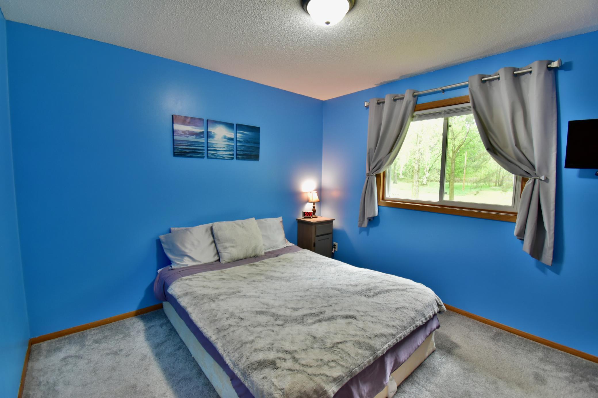 2nd bedroom on the main floor looking out to the backyard.