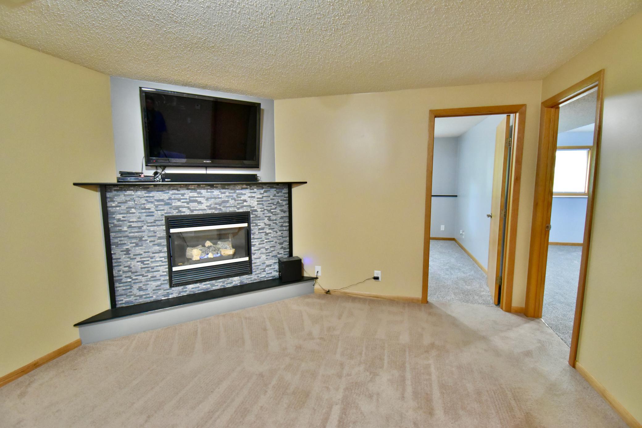 Gas fireplace adds lots of ambiance and warmth to the room on those chilly days. It is thermostat controlled. The TV above the fireplace stays with the home.