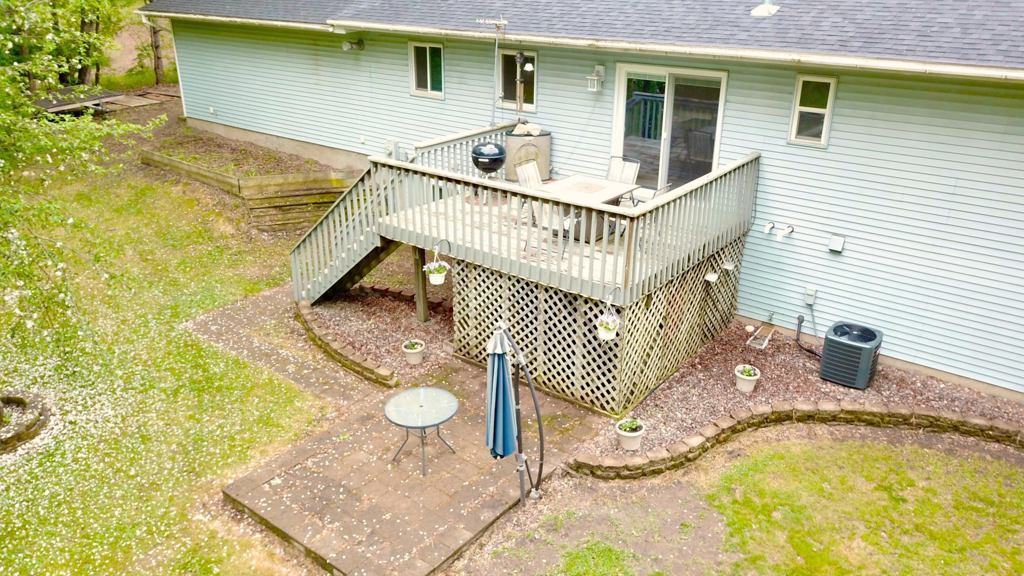 Large deck off the dining room that leads down to the patio. New AC and gutters.