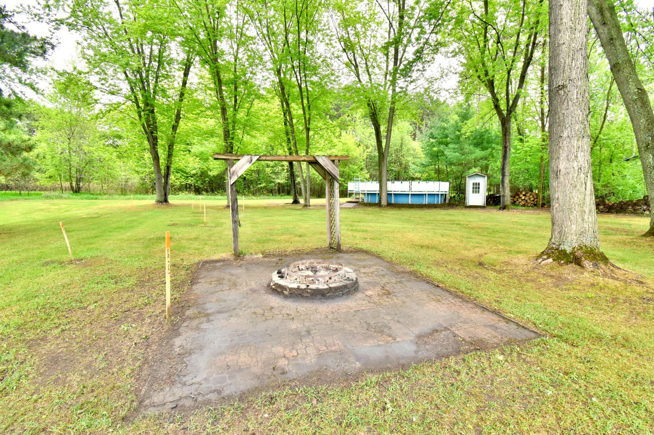 Fire pit near the center of the back yard.