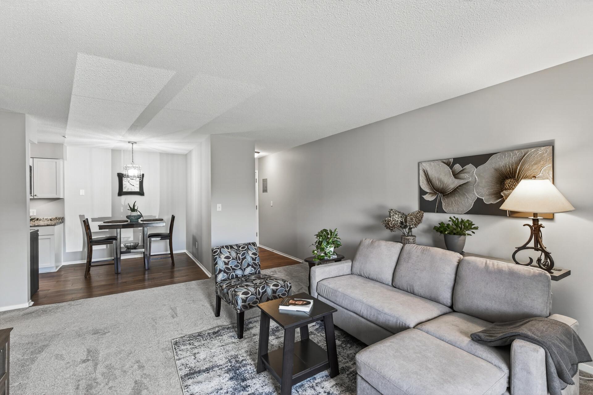 Warm and inviting living and dining spaces create an easy everyday flow, with the front door conveniently centered between the main living area and bedroom hallway.