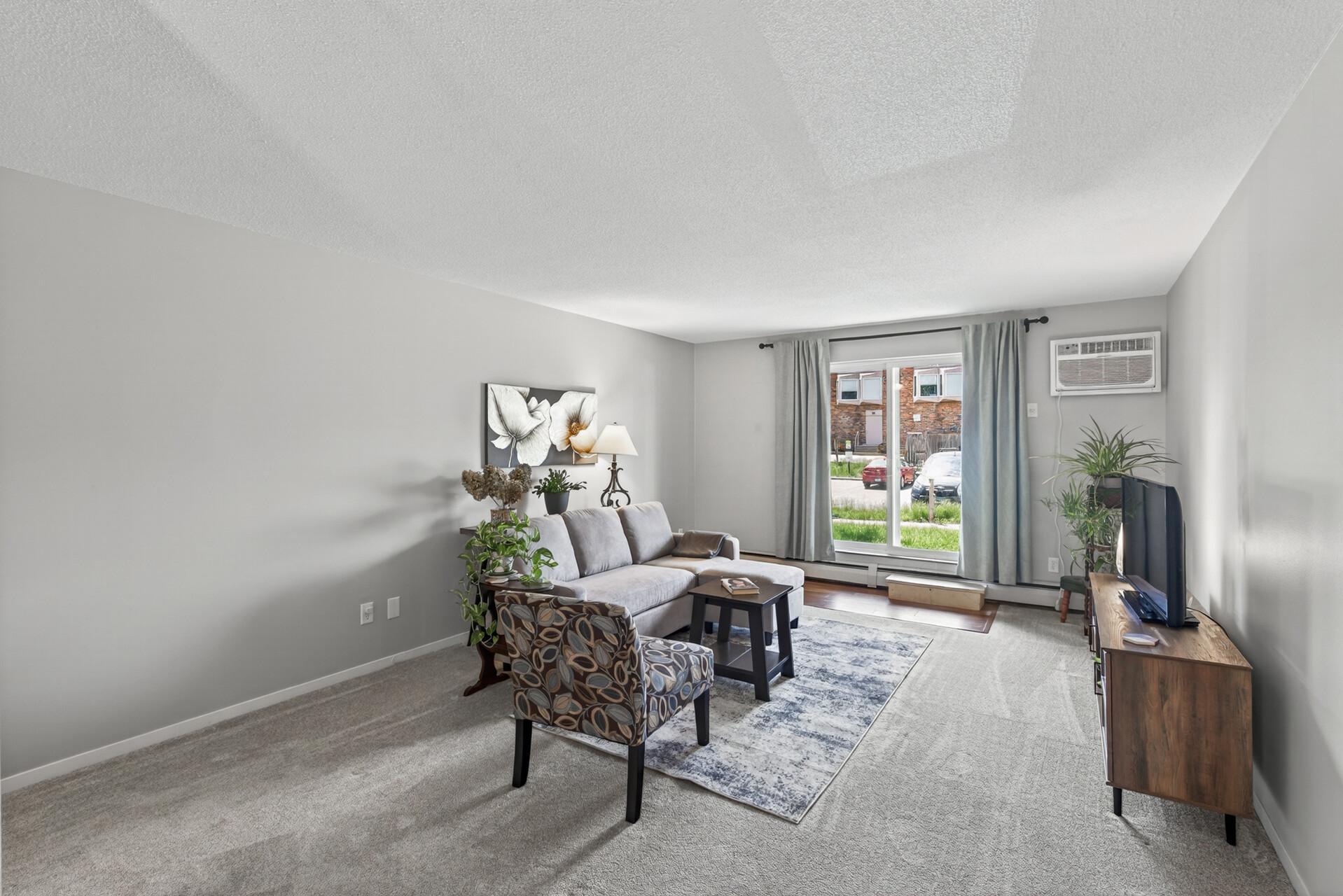Welcome to this spacious 2-bedroom, 1-bath ground-level condo with a large walk-out patio that gives it a townhome-like feel. Enjoy a generous living space, no-charge community laundry, and amenities including a saltwater pool and sauna.