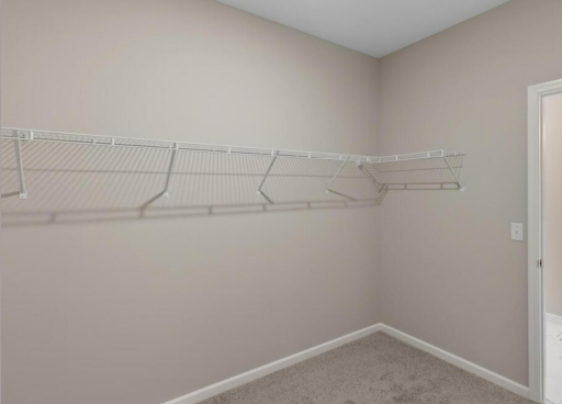 Primary Bedroom Closet - PHOTO OF A DIFFERENT HOME WITH SIMILAR PLAN. FINISHES MAY VARY.