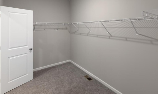 Primary Bedroom Closet - PHOTO OF A DIFFERENT HOME WITH SIMILAR PLAN. FINISHES MAY VARY.
