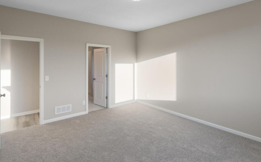 Primary Bedroom - PHOTO OF A DIFFERENT HOME WITH SIMILAR PLAN. FINISHES MAY VARY.