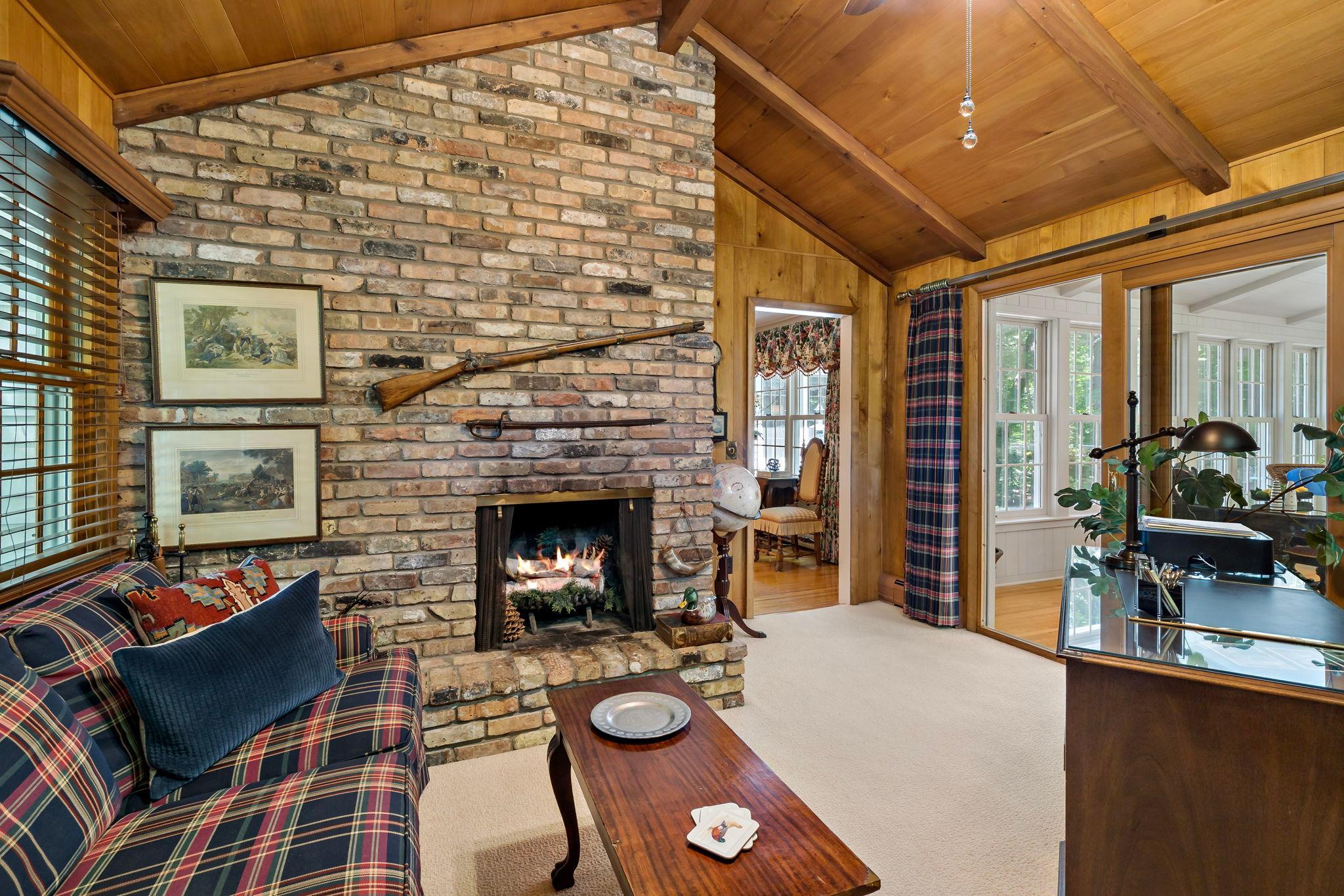 Wood burning fireplace and floor to ceiling brick surround