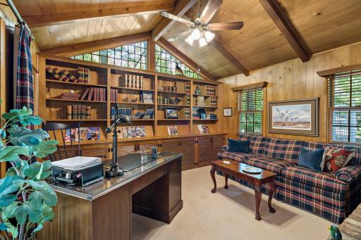 Main floor office with vaulted ceilings and an abundance of built-ins