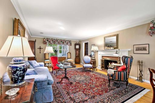 Formal living room with a wood burning fireplace