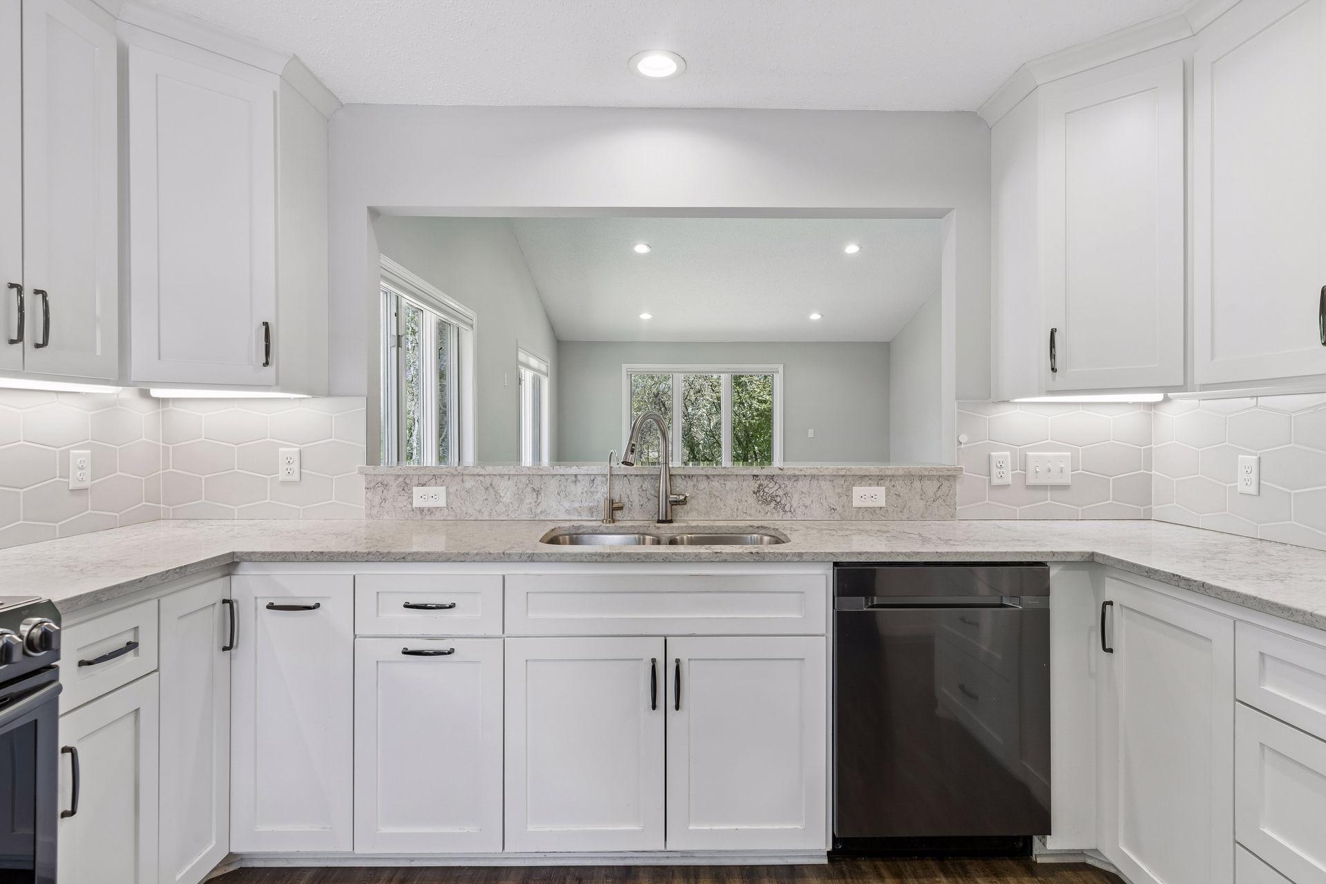 Open kitchen that looks through to dining and living room.