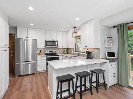 Kitchen featuring Quartz counter tops & glass tile backsplash. Whirlpool appliances (dishwasher, microwave, oven/range) 2020 and new refrigerator â24.