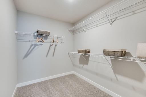 Large walk-in closet in the primary bedroom provides you with ample storage space. **Pictures are of model home; actual finishes will vary.