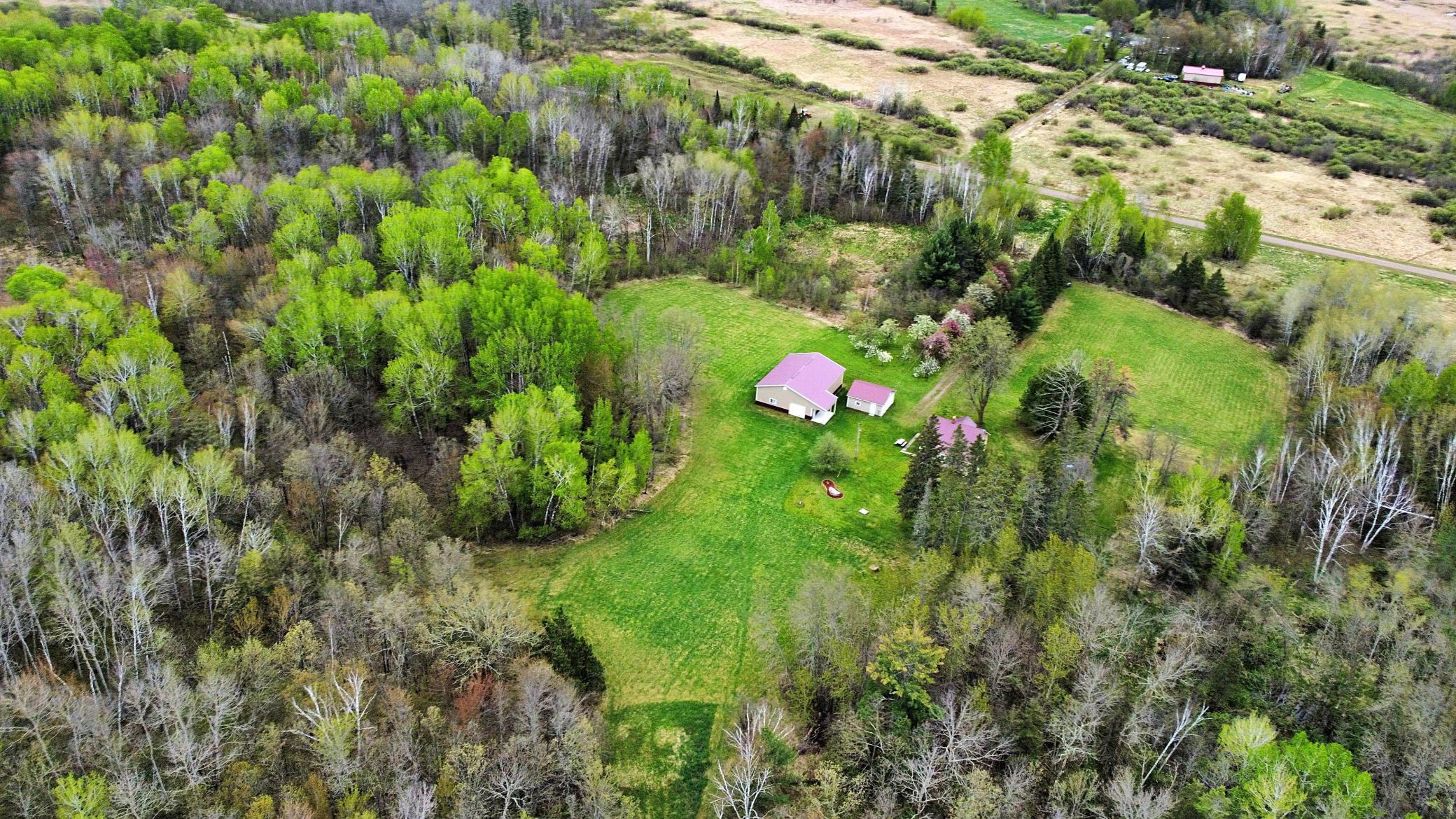 Aerial view over property buidlings and clearing.jpg