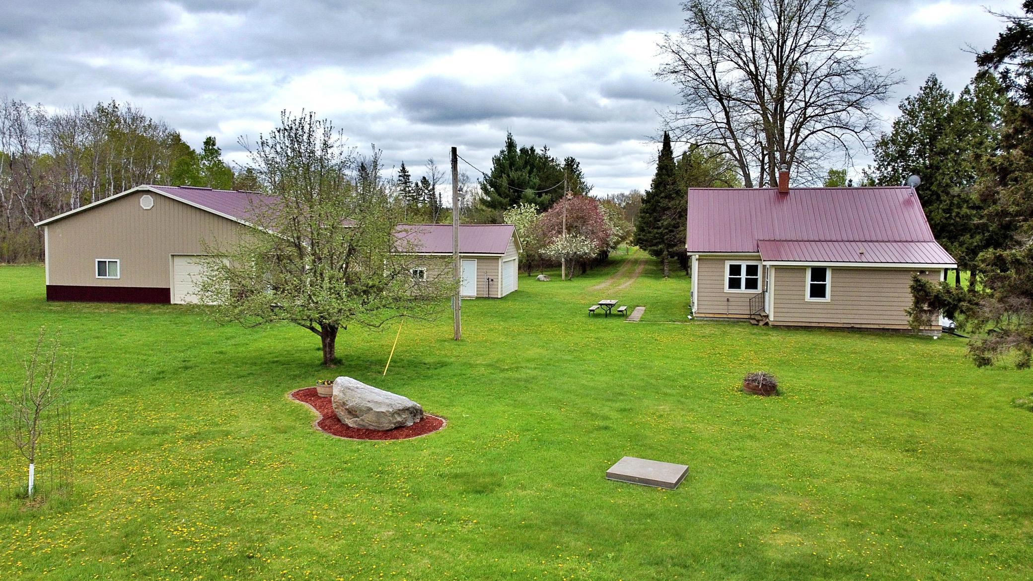 Property view of home garage and pole building .jpg