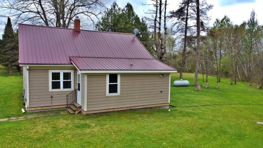 Home photo with metal roof and propane tank.jpg