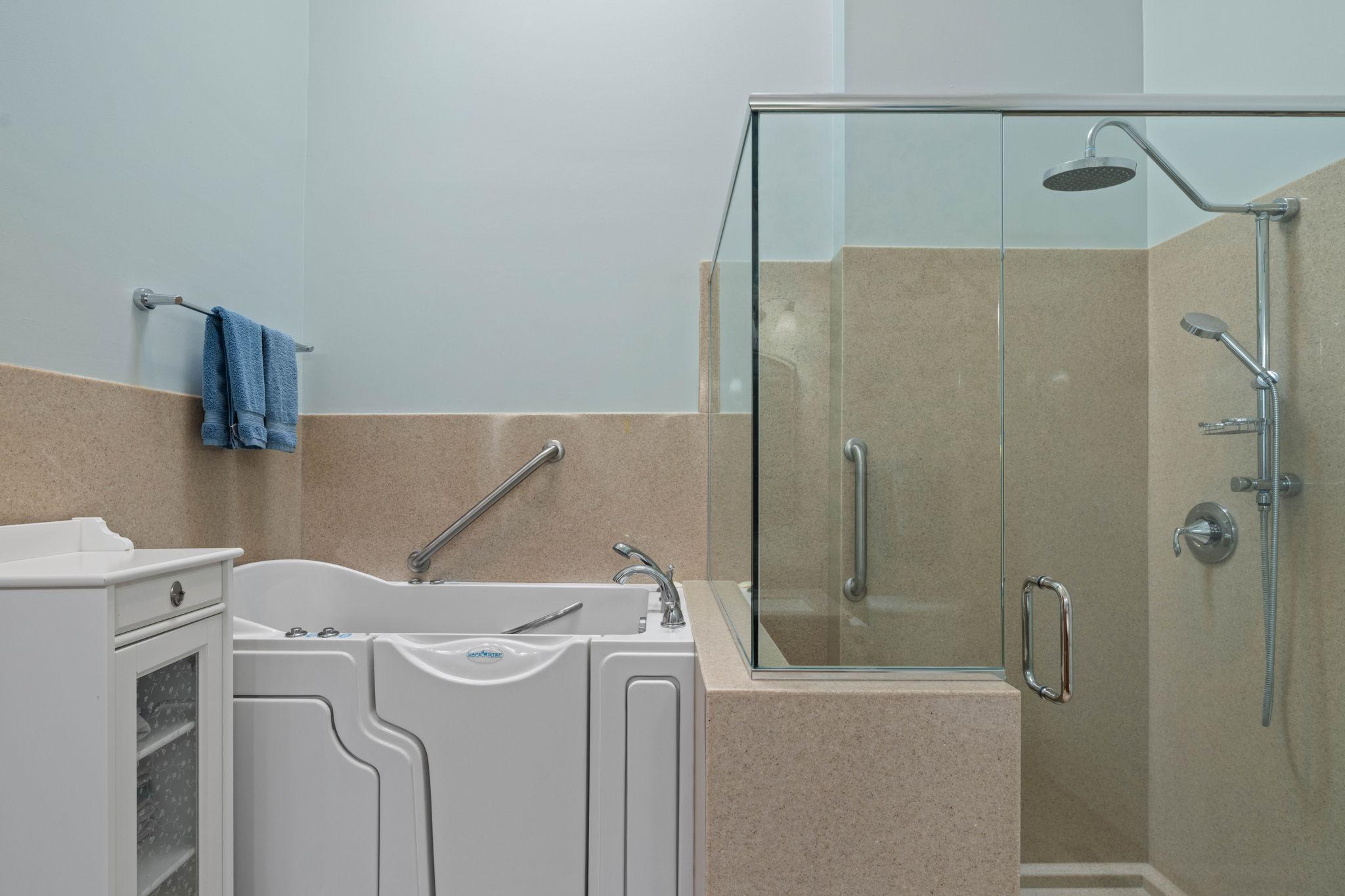 Main Level Primary Bath with walk in tub and separate shower