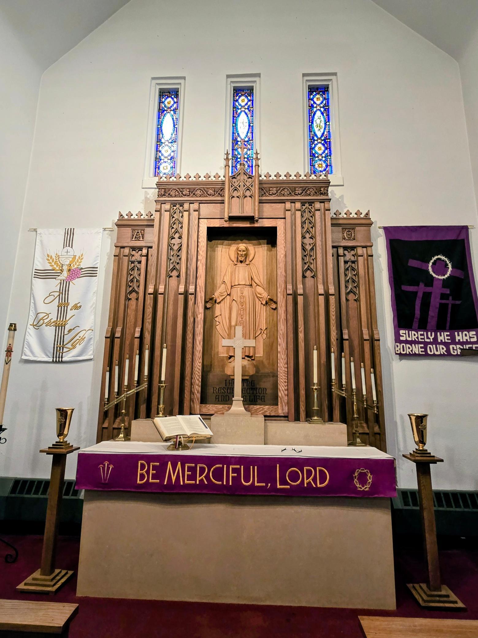 “A beautifully carved statue of Christ at the altar serves as a stunning focal point within the sanctuary, adding to the church’s rich history and craftsmanship.
