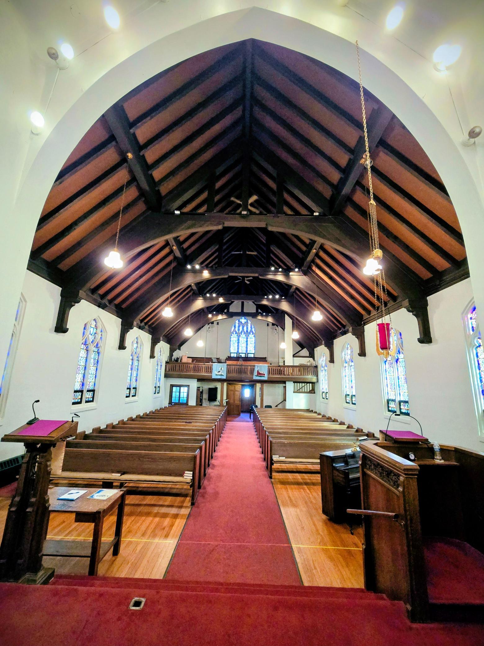 “Breathtaking sanctuary featuring soaring ship-hull style wood ceilings with exposed beams and remarkable architectural detail.”