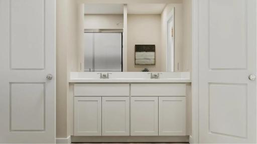 (Rendering, actual home's finishes will vary.) Dual sinks, built-in cabinetry and twin plate glass mirrors streamline everyday routines