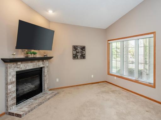 Inviting living area featuring vaulted ceilings and a gas fireplace.