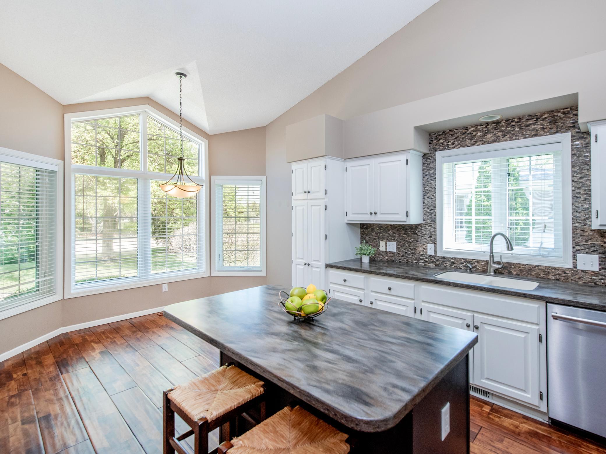 Open-concept kitchen and dining area filled with natural light.