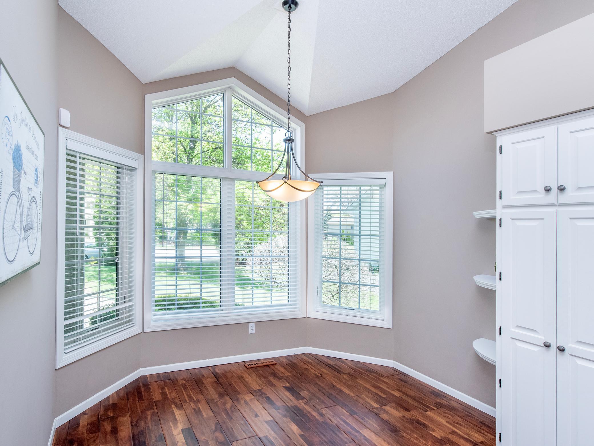Elegant eat-in dining space with architectural window design and elevated ceilings.