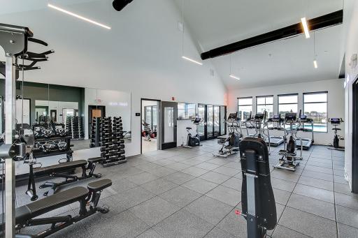 Spacious fitness center with weight training machines and free weights, treadmills, elliptical machines, and both stationary & spin bikes!