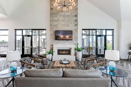 Gorgeous indoor gathering area, complete with waterfall quartz island, fireplace, TV, and plenty of cozy seating. Available for homeowners to reserve for gatherings.