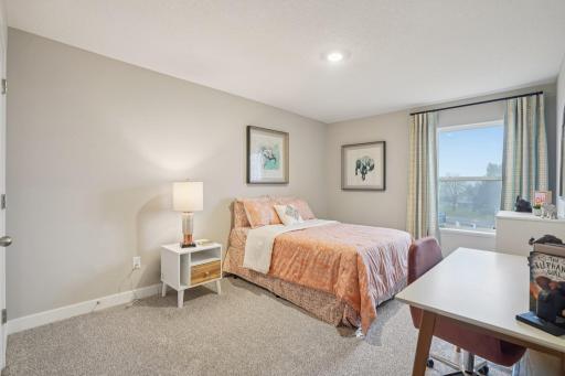 3 secondary bedrooms are all big and spaced out in each corner of the upstairs. Model photo, options and colors may vary.