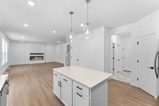 (Photo of a similar home, actual finishes may vary) The center island doubles as a breakfast bar, ready for casual meals and entertaining
