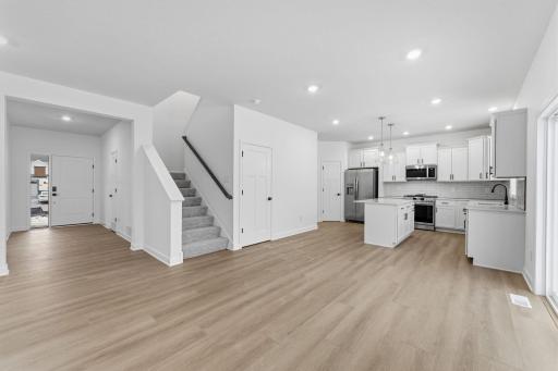 (Photo of a similar home, actual finishes may vary) The dining room is situated among the open floorplan, making it easy to move between the kitchen and Great Room.