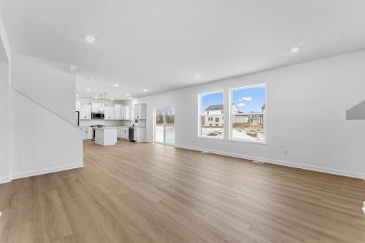 (Photo of a similar home, actual finishes may vary) The kitchen overlooks shared rooms within the open-concept layout