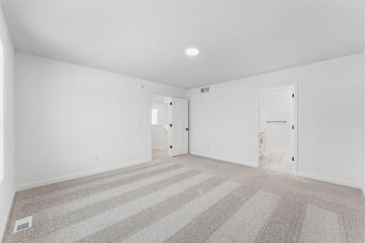 (Photo of a similar home, actual finishes may vary) This bedroom combines comfort and luxury with ease