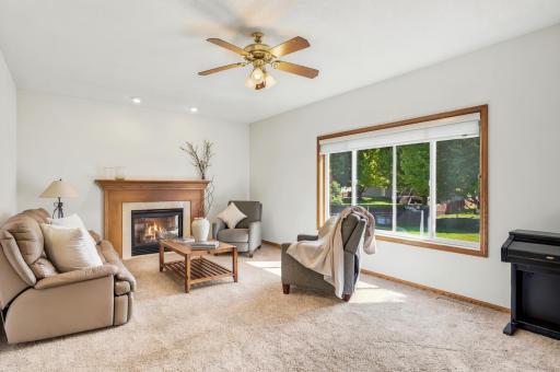 A beautiful gas fireplace anchors this welcoming living room filled with natural light!