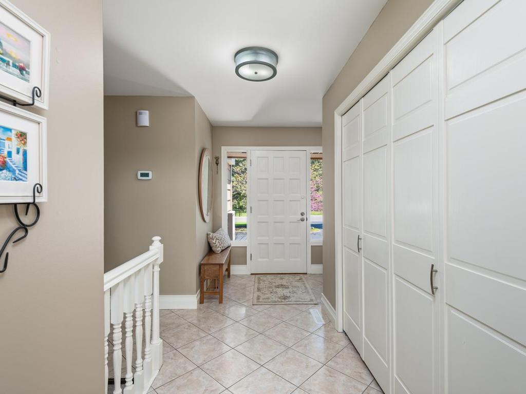 Inviting front Entry offers double coat closet with built-in shelving & bi-fold doors.