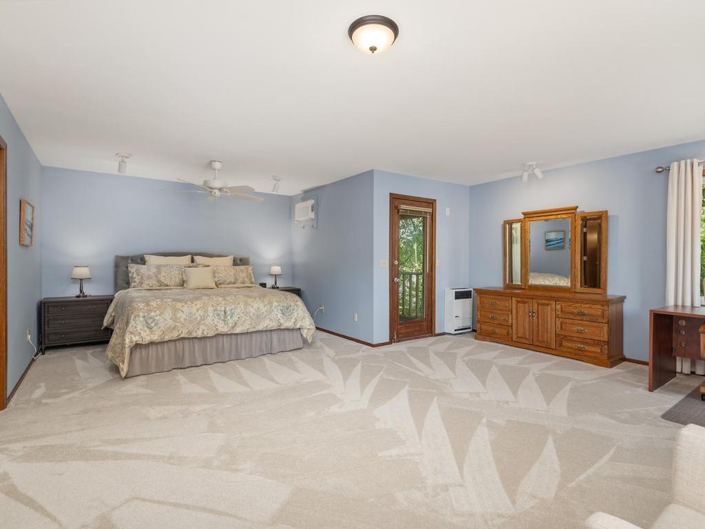 Huge Primary Suite features 2 walk-in closets, private "treehouse" screened porch, sauna, and private 3/4 bath.