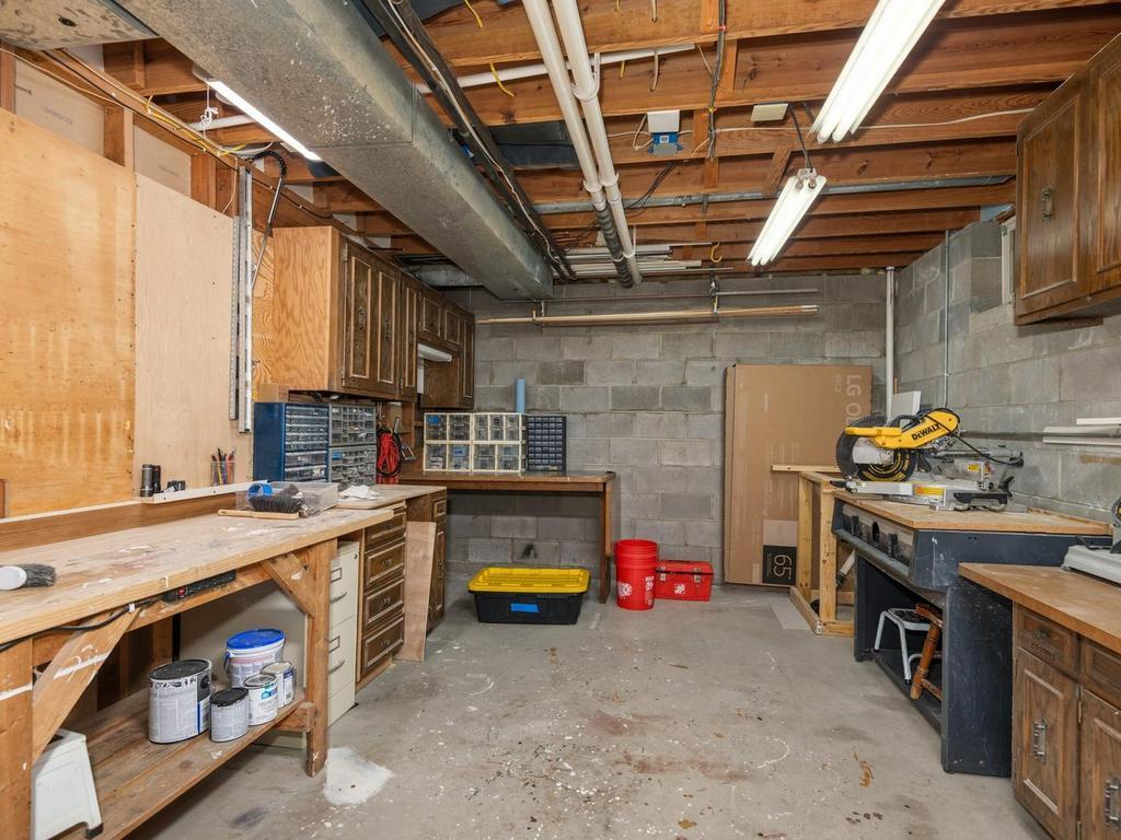 The basement level also has this great workshop with workbench - perfect for tinkering or other home improvement projects!